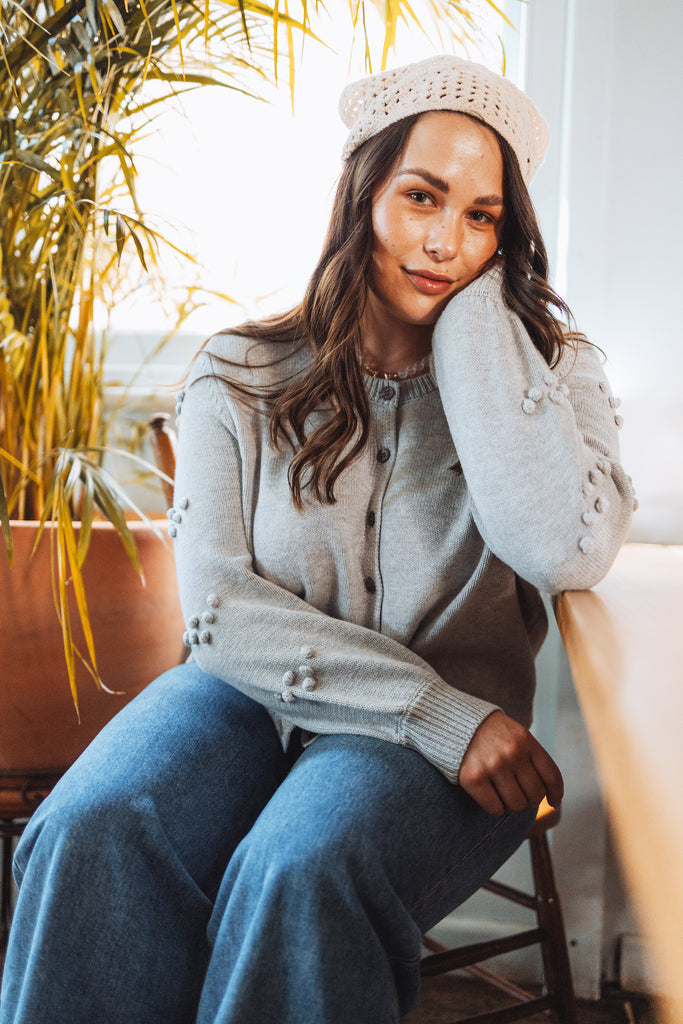 model wears thrd label camellia cardigan in grey marle with boho crochet headscarf and henne jeans with the row inspired jelly shoes