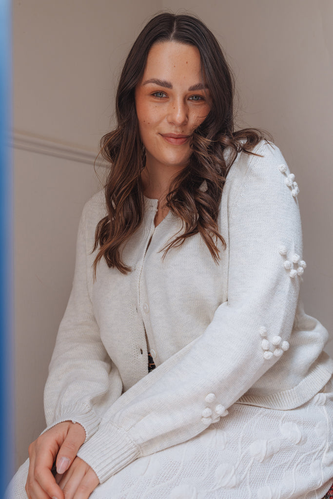 model in thrd label camellia cardigan white marle with white dress